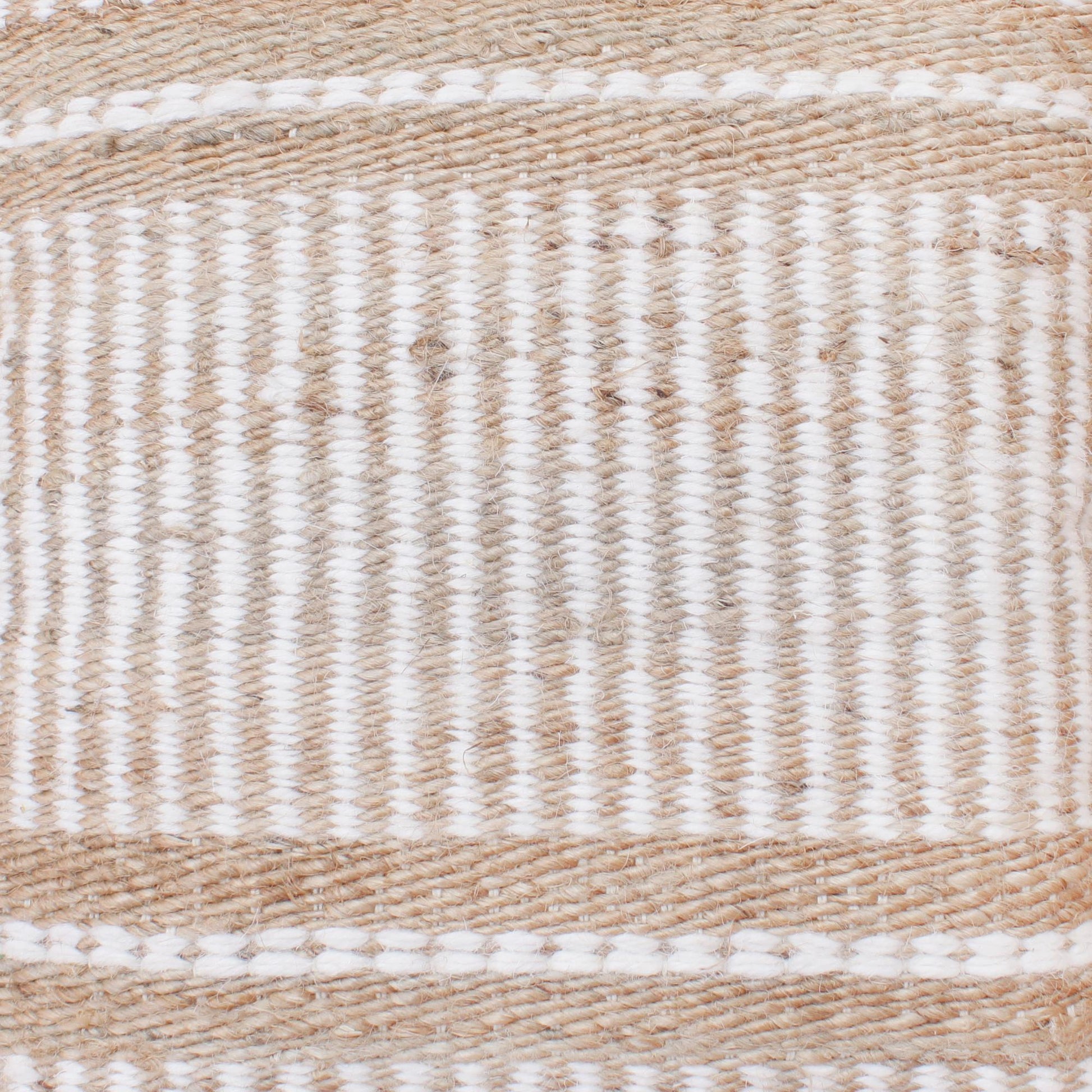 Close-up of a woven beige and white rug with a striped pattern.