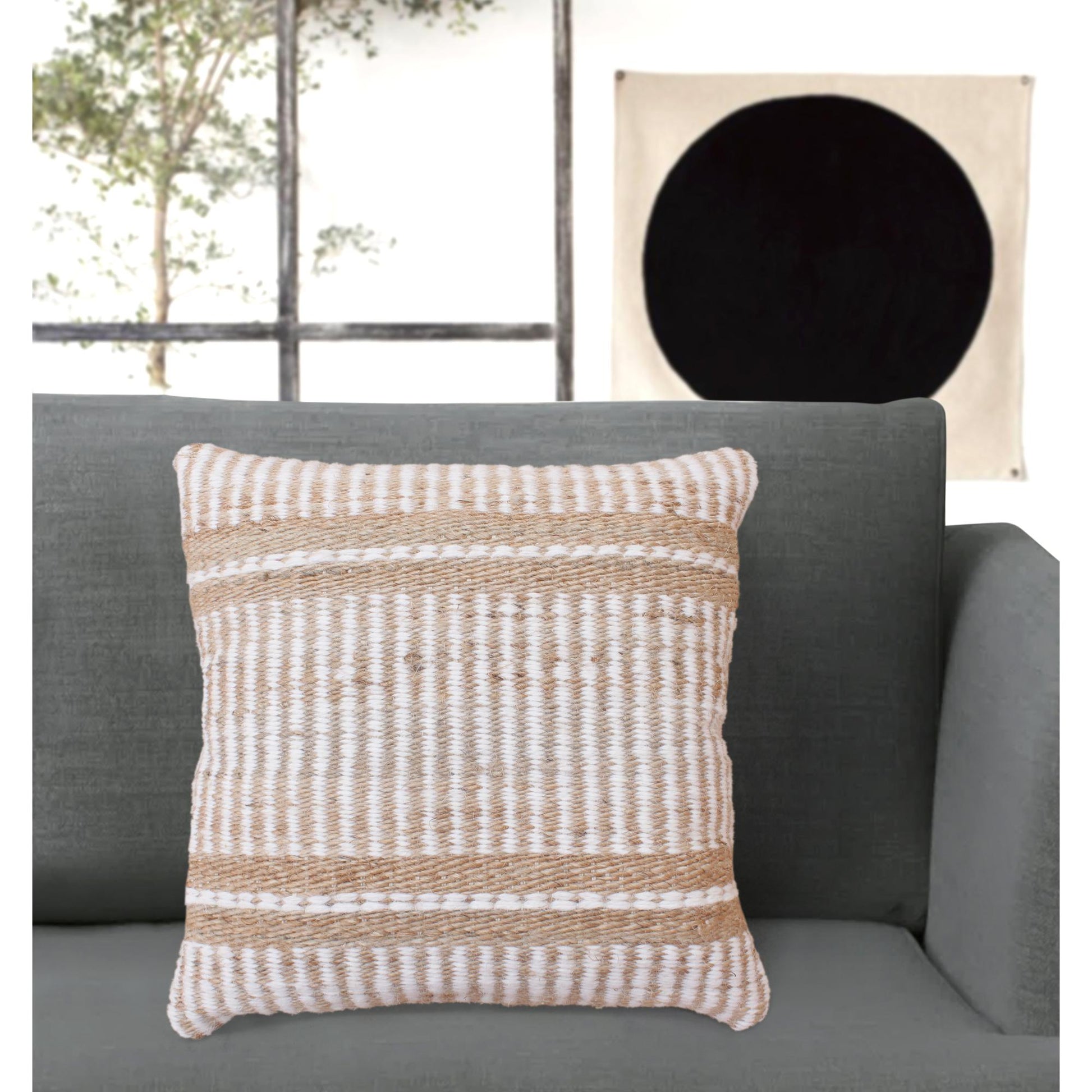 Textured throw pillow on a gray sofa with a neutral wall in the background